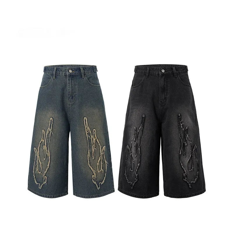 Men's black denim shorts with flame embroidery detail on straight-leg cut