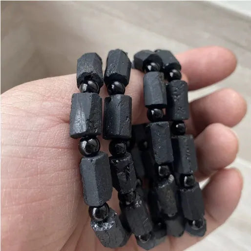 Natural black tourmaline rough stone bracelet with 10mm beads showing textured stone surfaces