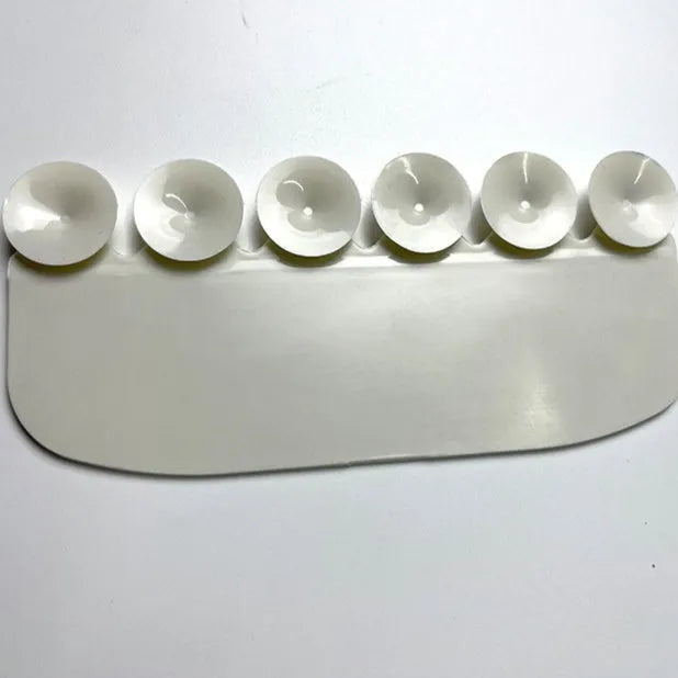 White PVC toilet urine splash guard board for boys potty training on a toilet seat.