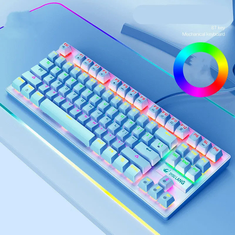 Compact mechanical gaming keyboard with RGB lighting next to laptop