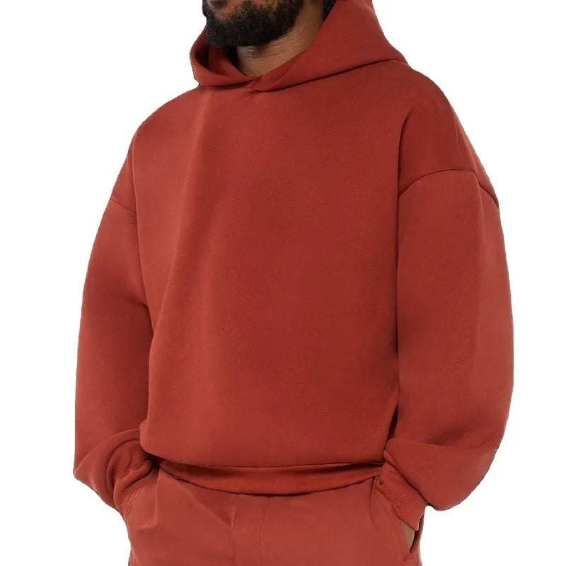 Man wearing a solid colour fleece-lined cotton pullover hoodie with a wool lining.