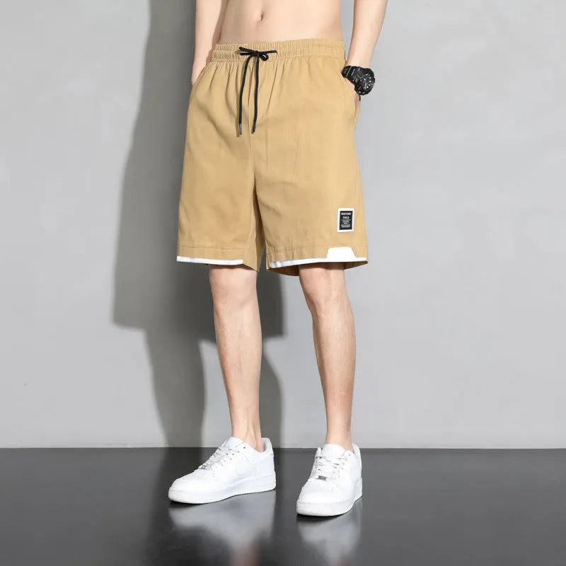 Cotton shorts for teenage boys in black, khaki, and white, showing mid-waist fit and shorts length.