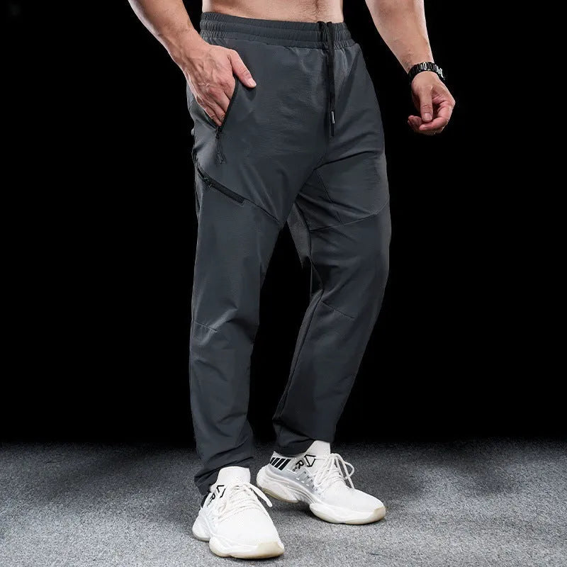 Men's waterproof quick-dry nylon workout trousers in multiple colours on a size chart.
