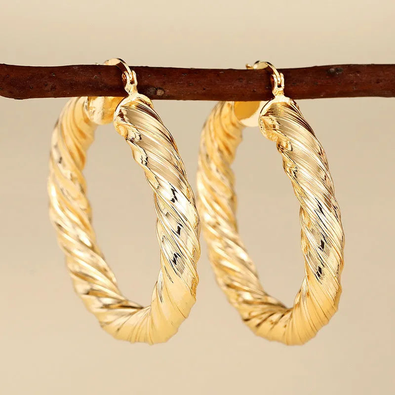 Geometric drop-shaped women's ear clip with ring design in electroplated copper.