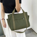 Women's large capacity canvas tote bag with multiple internal pockets in horizontal square design