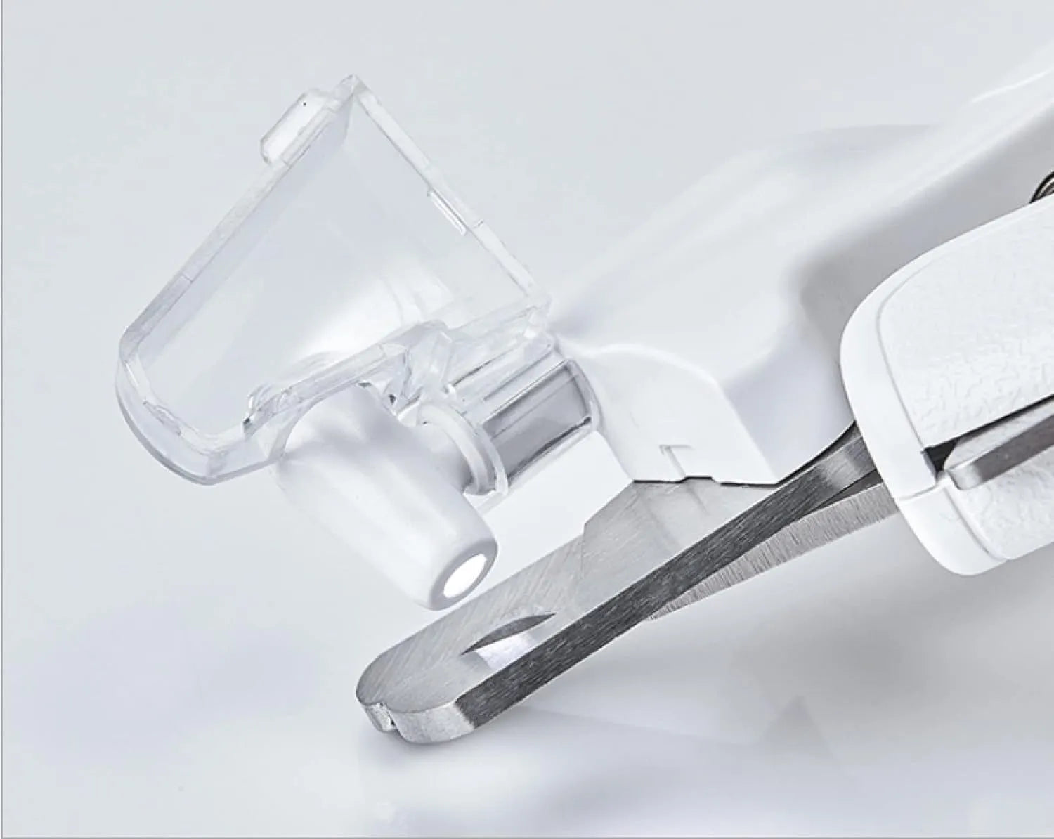 White LED pet nail clipper with transparent anti-splash guard open, showing triangular stainless steel blade