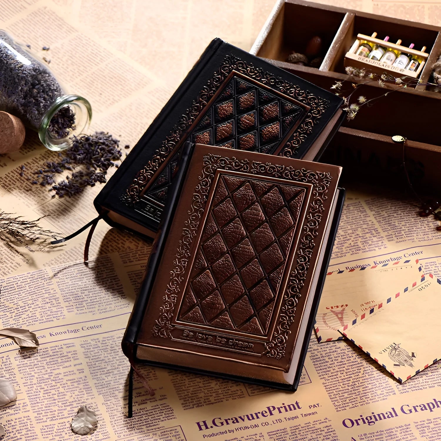 A5 hardback notebook with embossed faux leather cover in bronze colour, shown open on a table.