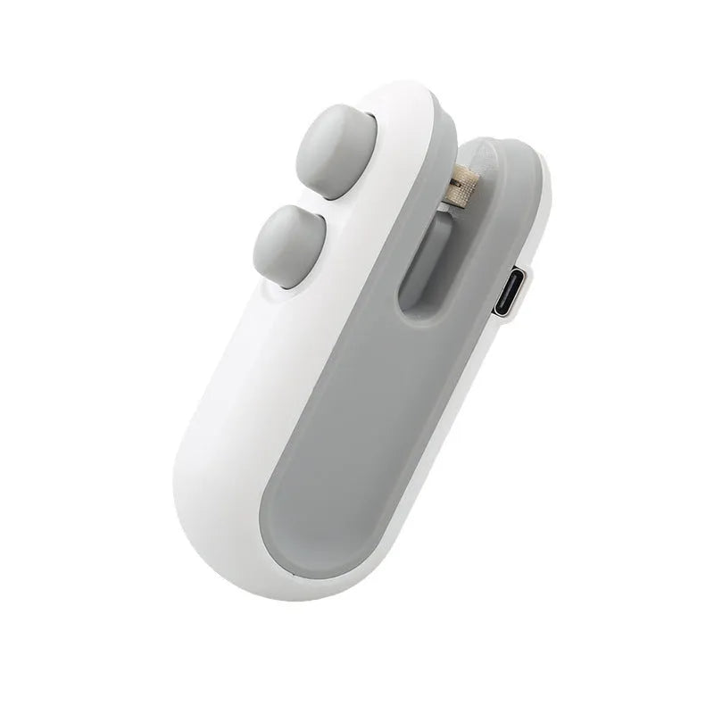 Handheld white vacuum sealer with cutter blade and magnetic back for bag sealing