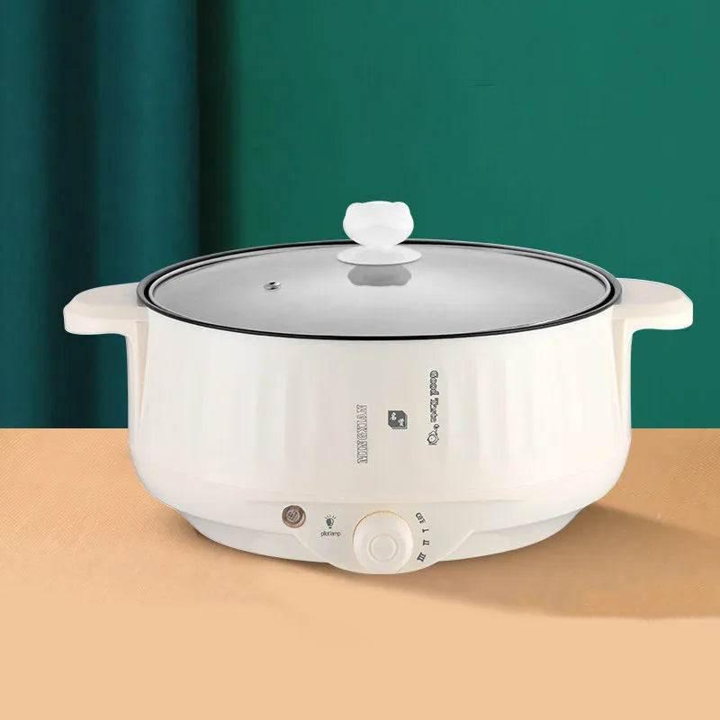 Stainless steel electric hot pot with non-stick coating and integrated heating base.