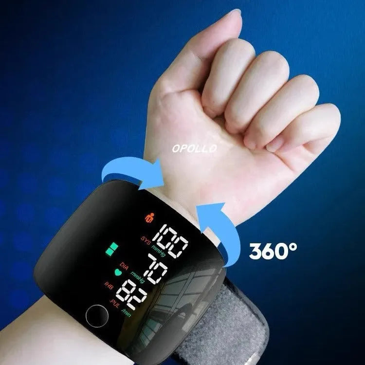 Black wrist blood pressure monitor with USB charging port and digital display.