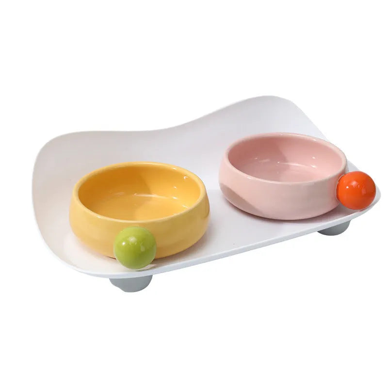 Elevated ceramic pet feeding bowl set with two bowls on raised platform