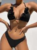 Black women's bikini set with gathered top and matching shorts laid flat.