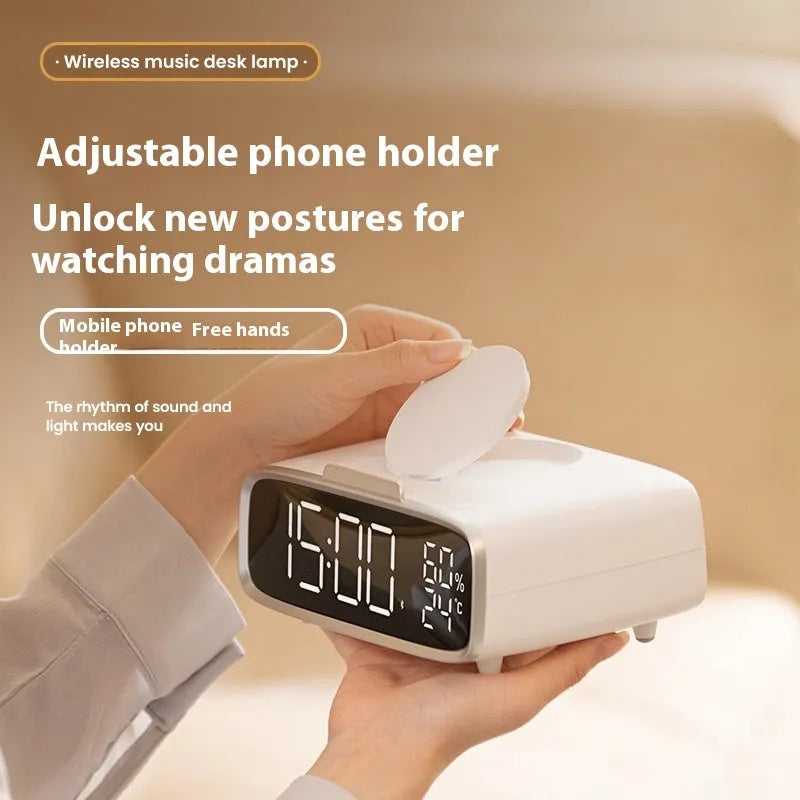 White compact Bluetooth speaker with integrated wireless charging pad and night light on a table