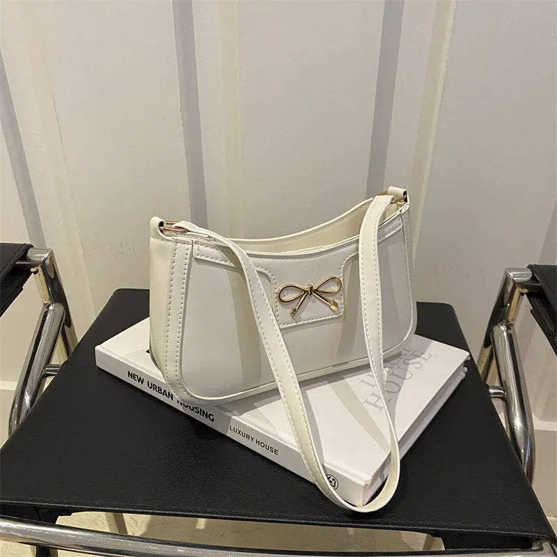 Western-style baguette shoulder bag in PU leather with bow detail, 24cm wide