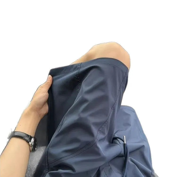 Men's quick-drying sports shorts in creamy-white, black, and navy blue colours
