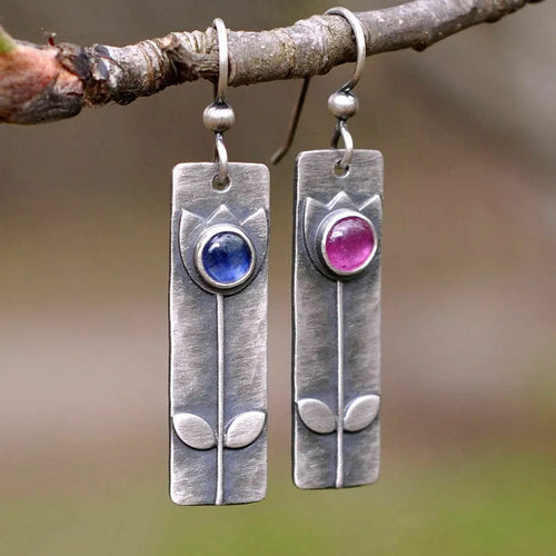 Antique finish red sapphire earrings with geometric oval shape and electroplated metal construction