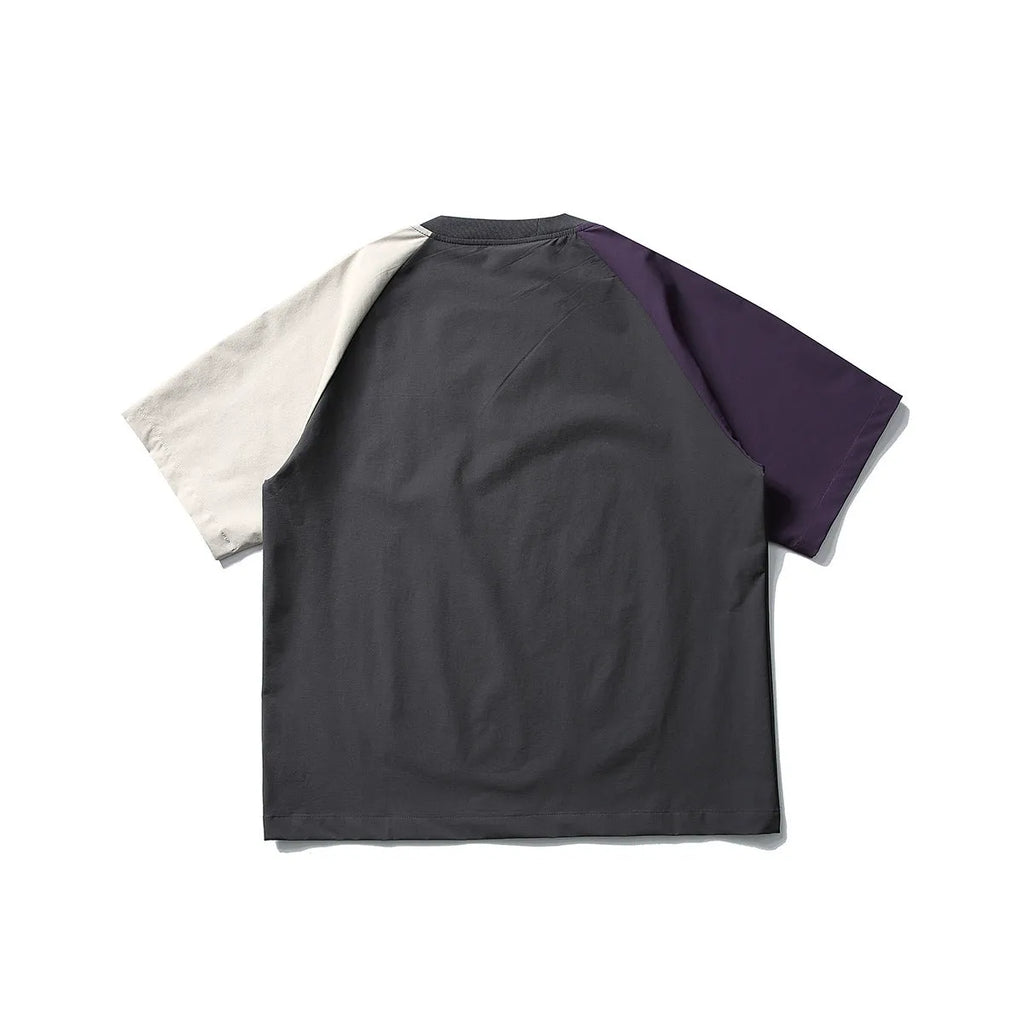 Dark grey men's loose fit T-shirt with contrast colour raglan sleeves on a hanger.