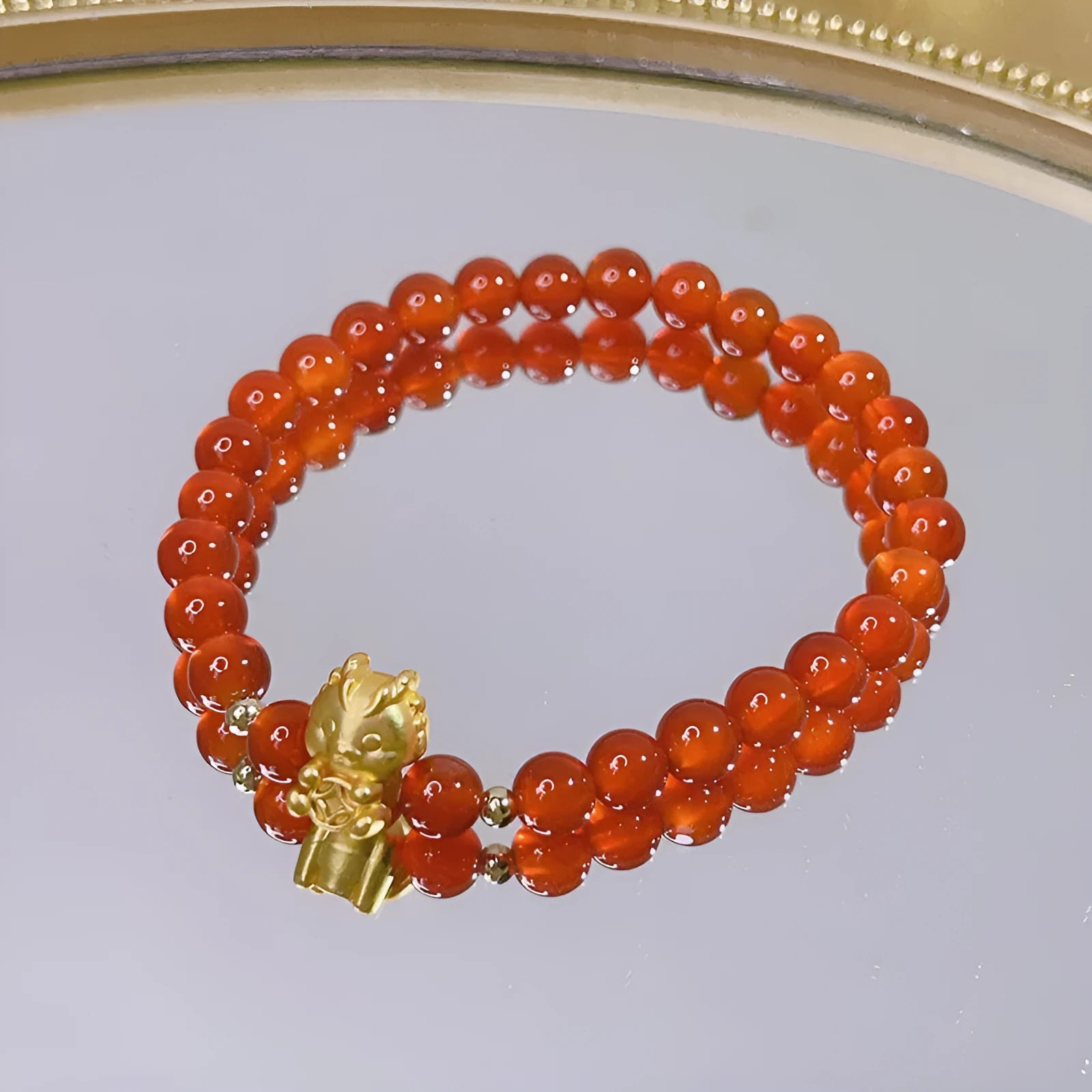Women's red agate bracelet with Chinese dragon design, a handcrafted gift for Bamboo Festival.