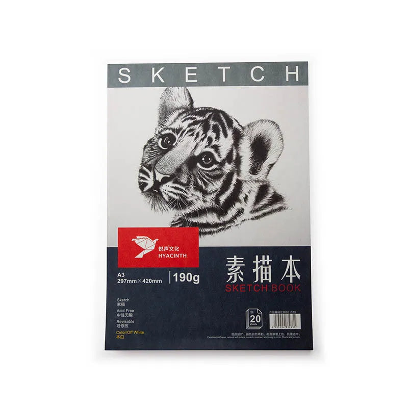 A4 sketchbook with coil binding lying flat open, showing blank heavyweight drawing paper.