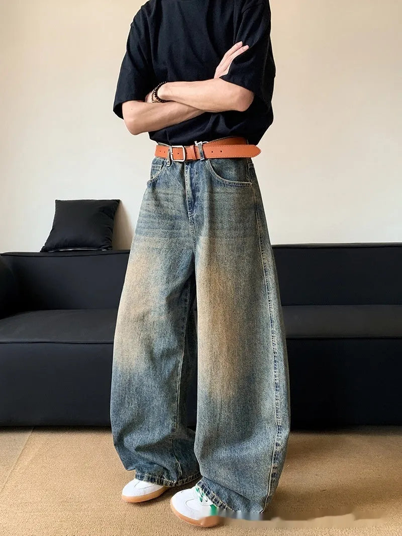 Men's retro blue distressed denim wide-leg trousers showing distressed detailing and wide-leg silhouette