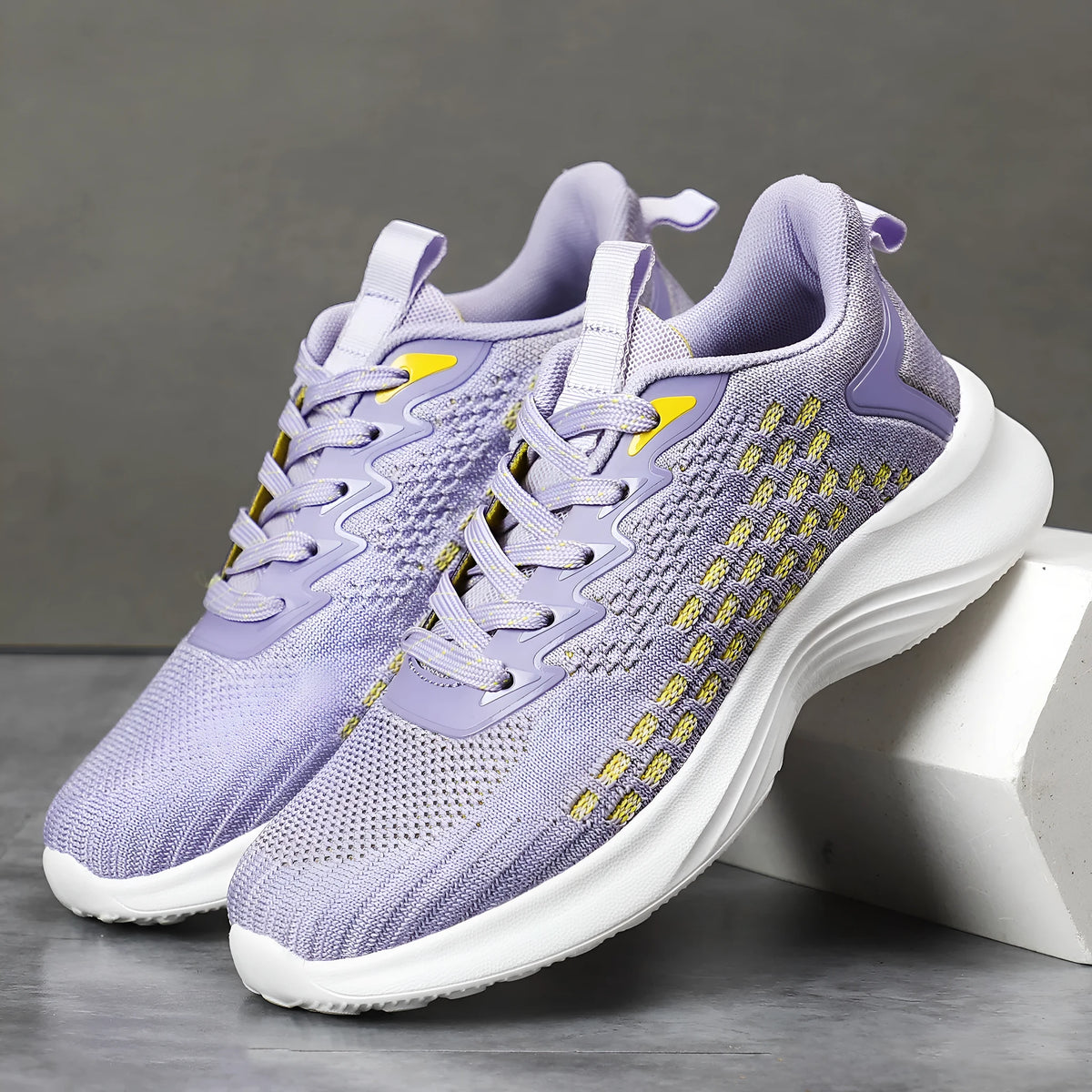 Women's lavender purple and blue Flyknit running shoes with mesh lining and striped pattern.