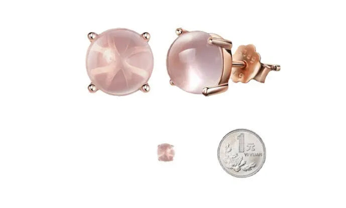 Close-up of women's drop-shaped synthetic quartz stud earrings with a rose gold finish.