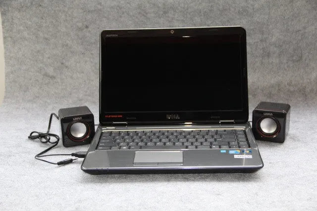 Black square USB-powered 2.0 computer speaker on desktop