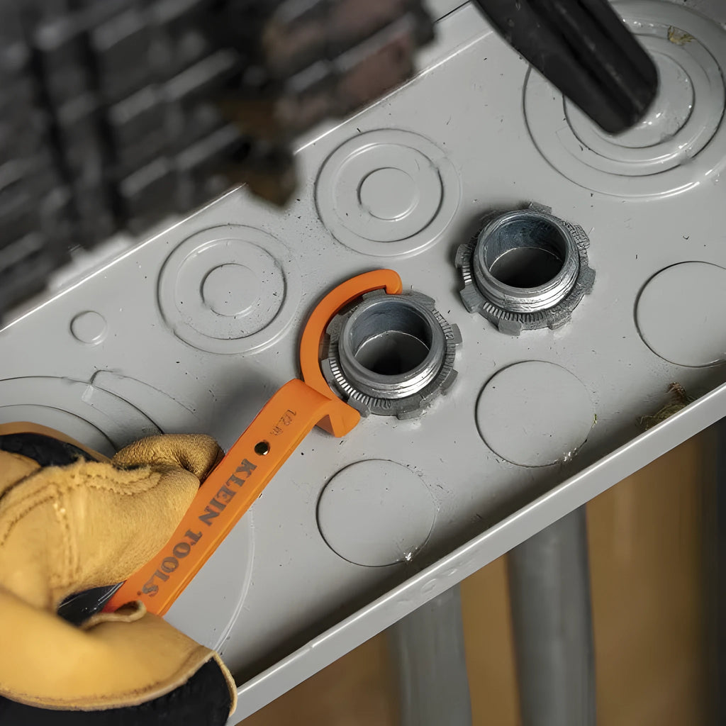 Orange, grey, and black crescent wrenches from a three-piece magnetic suction set for catheter locking.
