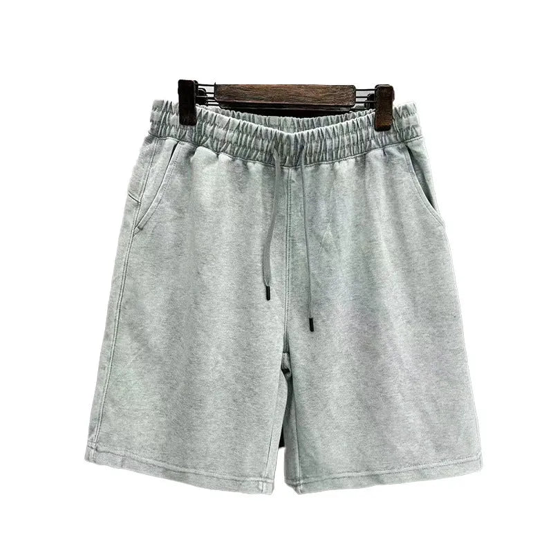 Men's distressed cotton shorts in solid colours with loose straight leg cut