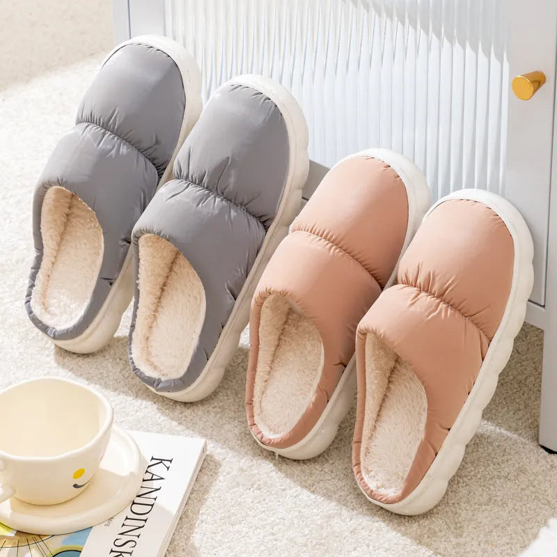 Blue winter indoor slippers with thick rubber sole and plush lining, shown on a hard floor.