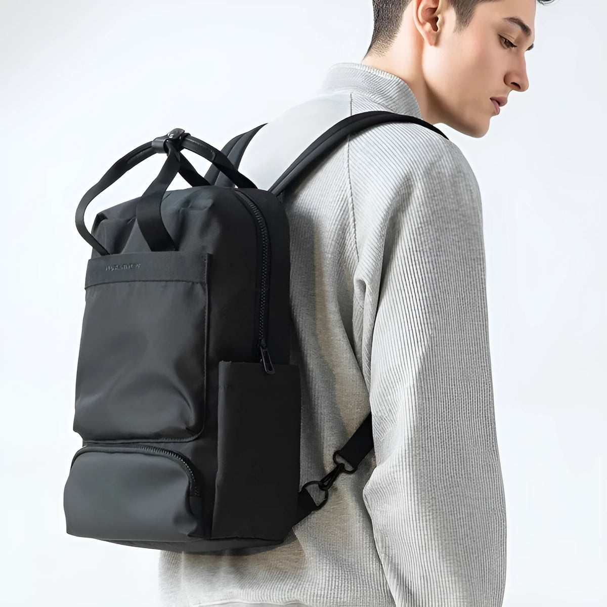 Black oxford cloth computer backpack with multiple compartments showing 20-35 litre capacity