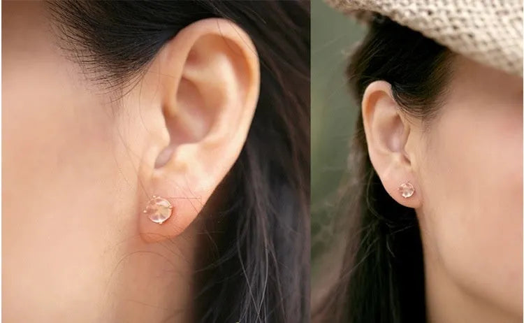 Close-up of women's drop-shaped synthetic quartz stud earrings with a rose gold finish.