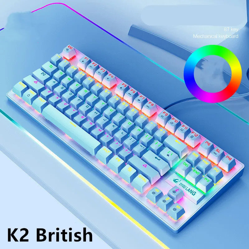 Compact mechanical gaming keyboard with RGB lighting next to laptop