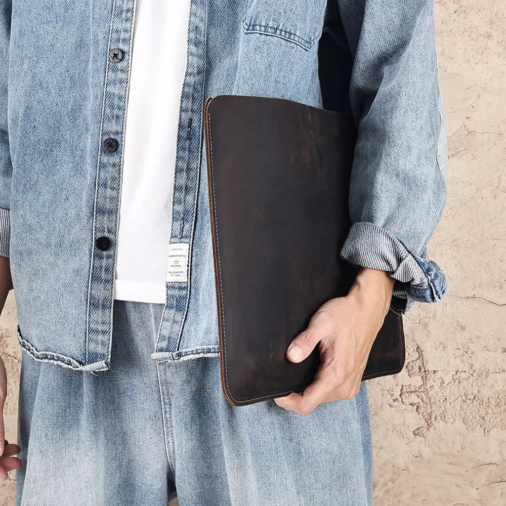 Brown genuine leather horizontal computer liner bag with cowhide lining showing interior compartments