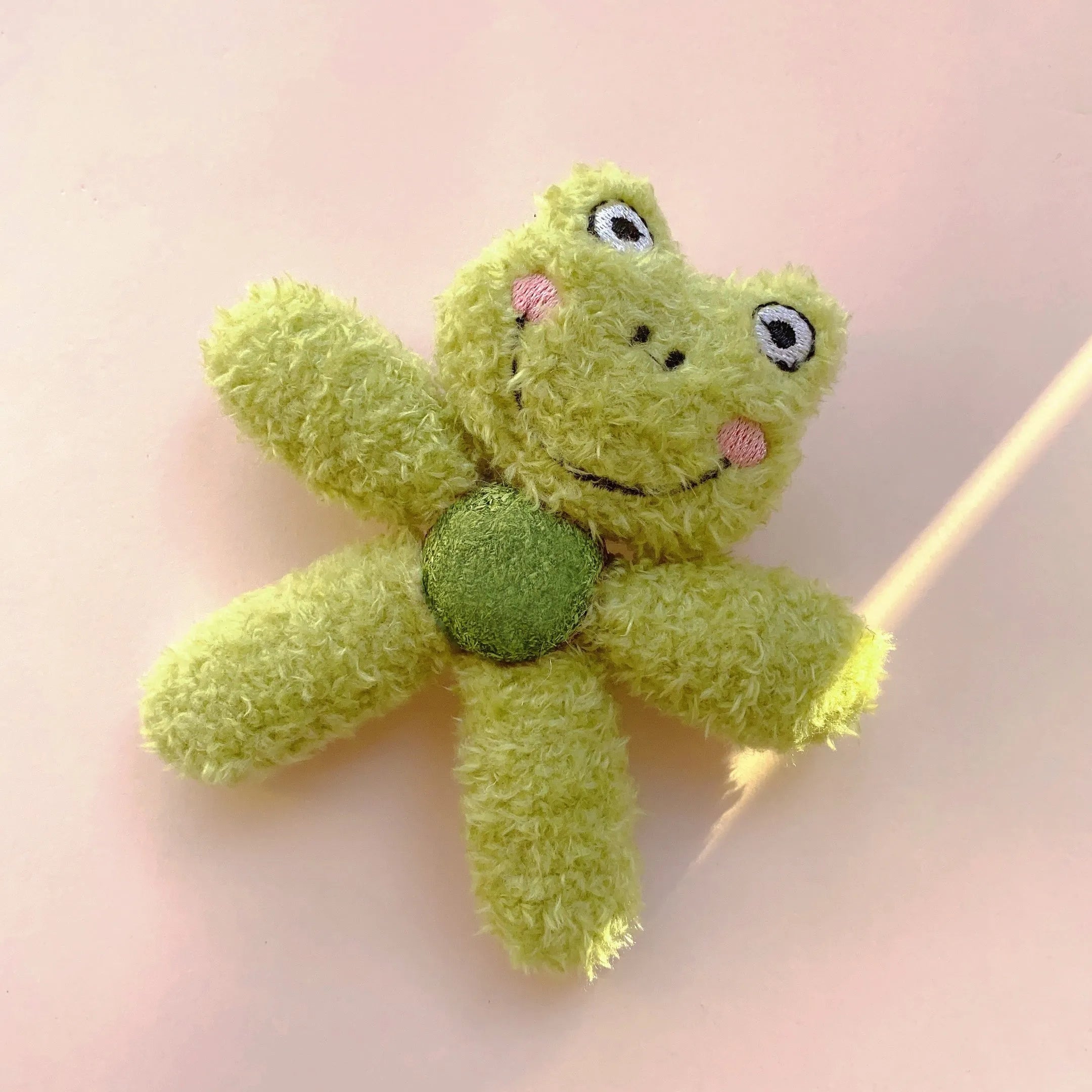 Soft stuffed catnip ball toy in animal design for chewing and play.