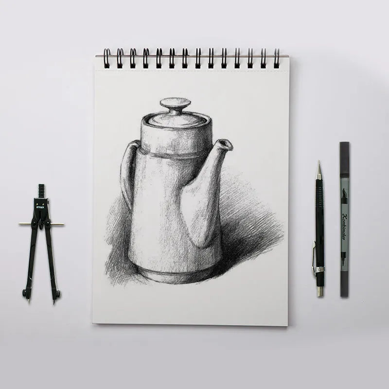 A4 sketchbook with coil binding lying flat open, showing blank heavyweight drawing paper.