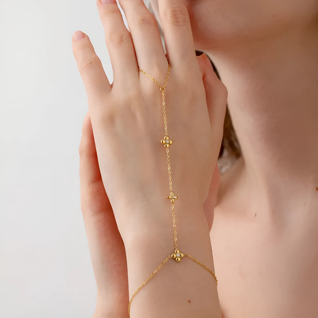 Gold stainless steel women's bracelet with geometric flower and eight-pointed star design.