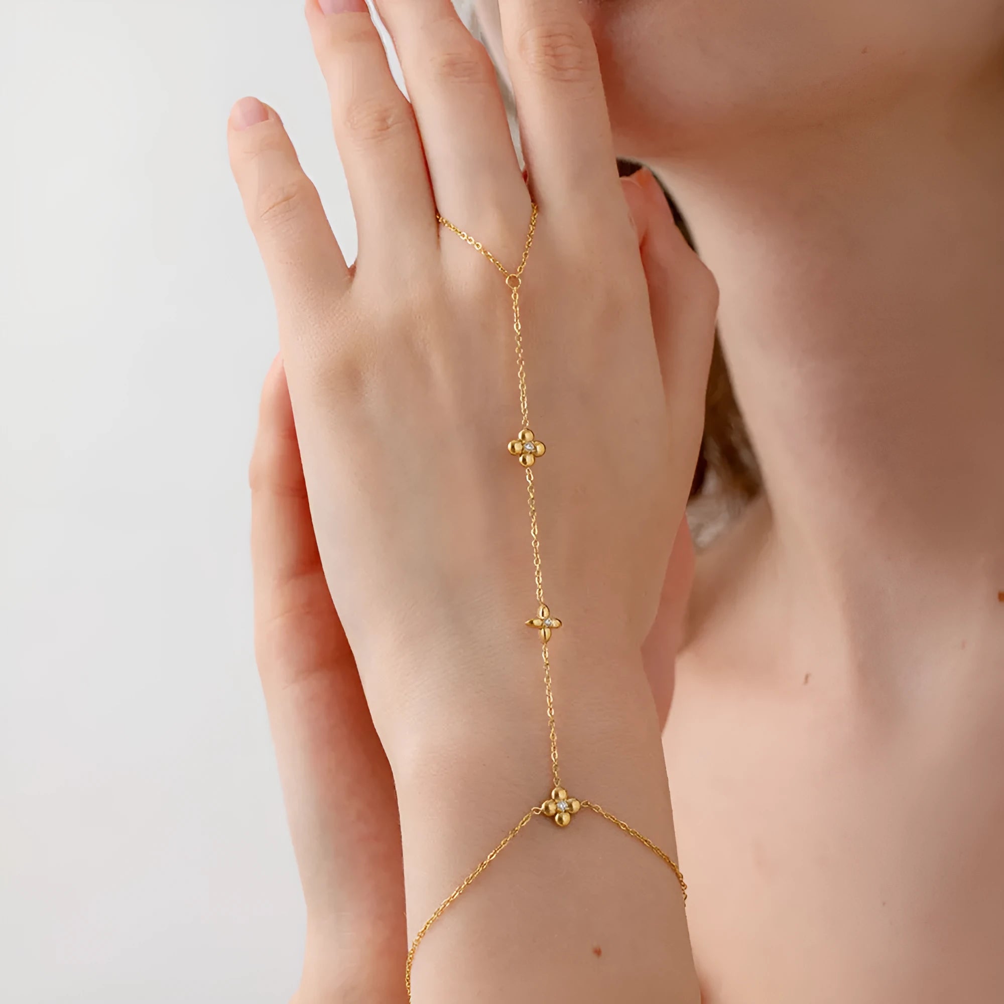 Gold stainless steel women's bracelet with geometric flower and eight-pointed star design.