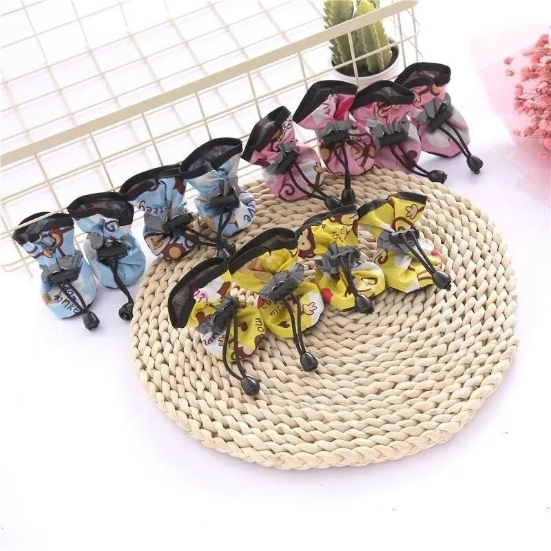 Cloth dog shoes with soft soles in multiple colours including red, black, blue, and monkey print designs