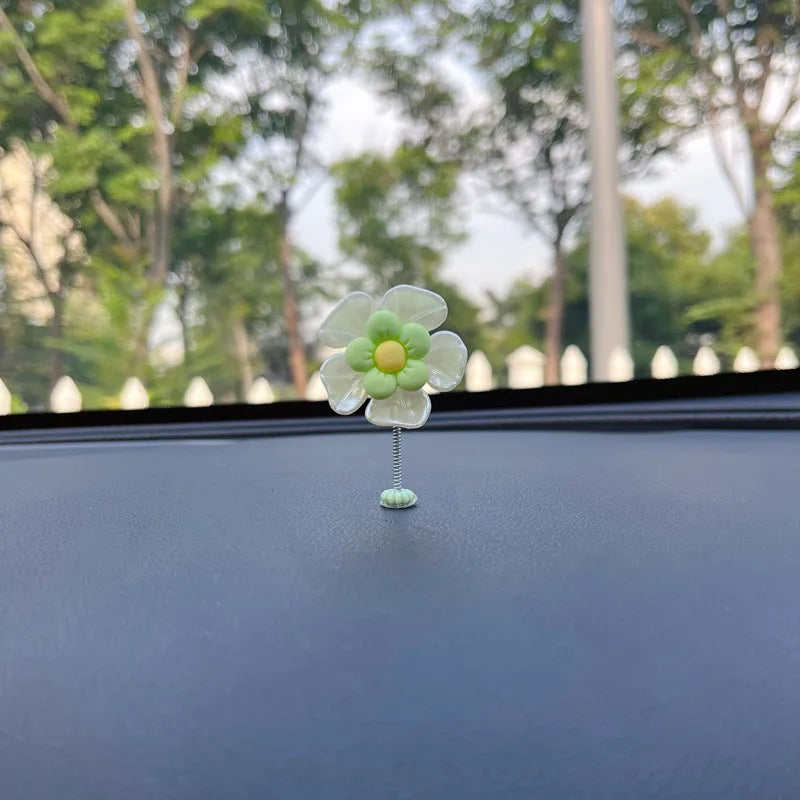 Small colourful plastic swing car decoration in blue, green, pink, purple, and yellow options.