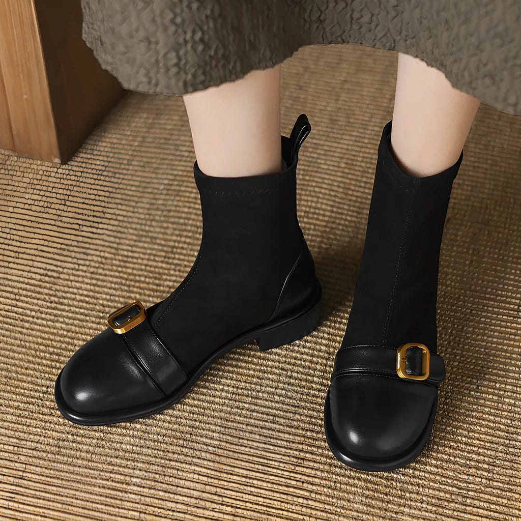 Women's black low heel Martin ankle boots with lace-up front and buckle stitch detail on a white background.