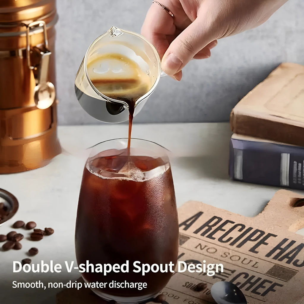 Transparent clear glass coffee cup with double spout design showing two drinking openings