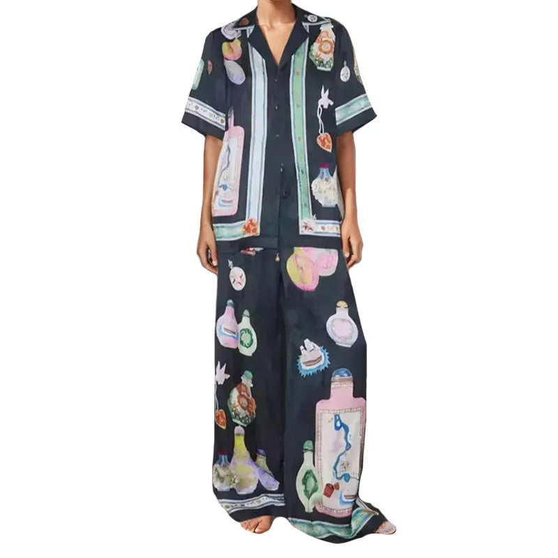 Women's black casual matching set with cartoon animation print, featuring a cardigan sleeve top and trousers