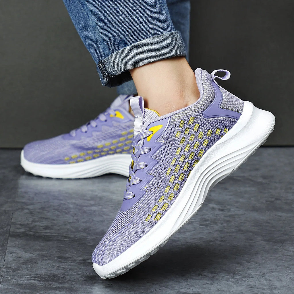 Women's lavender purple and blue Flyknit running shoes with mesh lining and striped pattern.
