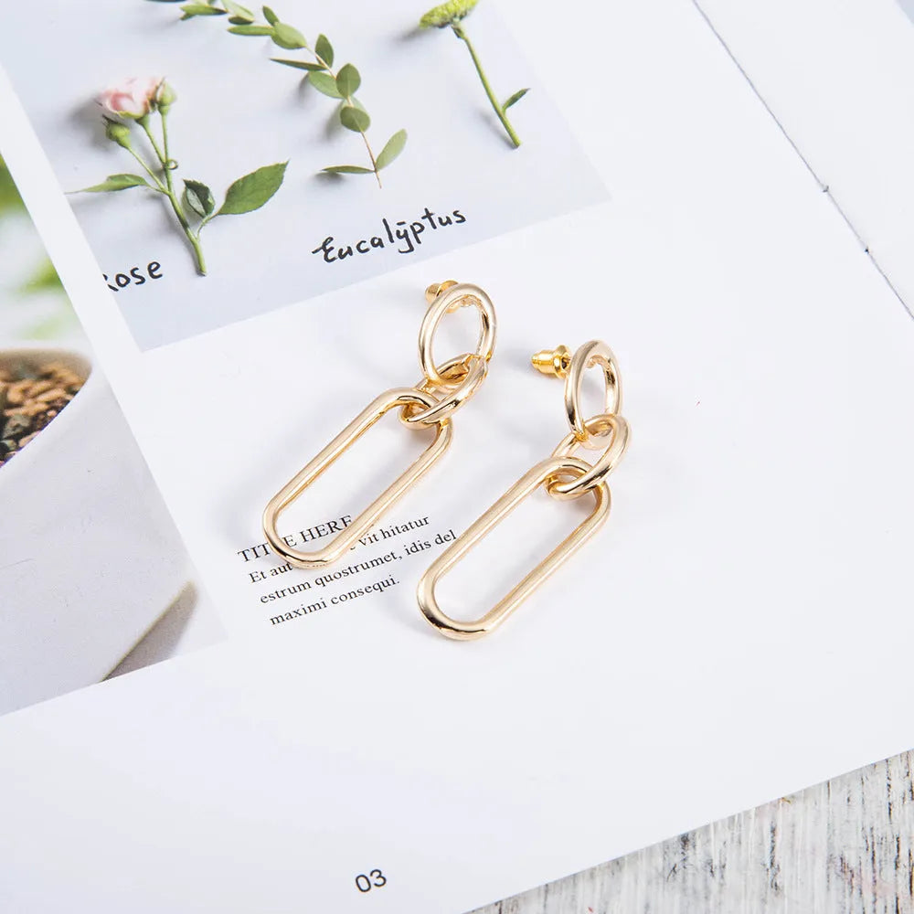 Geometric sterling silver needle hoop earrings with ring and line design elements