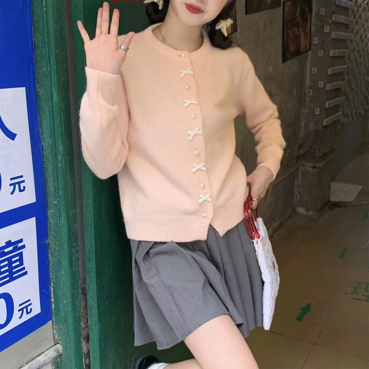 Women's solid colour cardigan with pearl buttons and bow pattern detail on cashmere-style fabric
