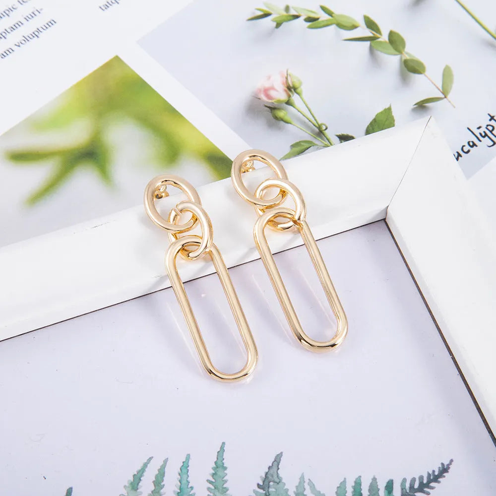 Geometric sterling silver needle hoop earrings with ring and line design elements