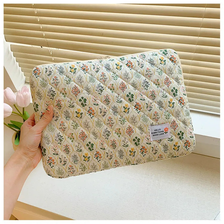 Green floral print cloth laptop bag shown next to red heart and pink floral design options.