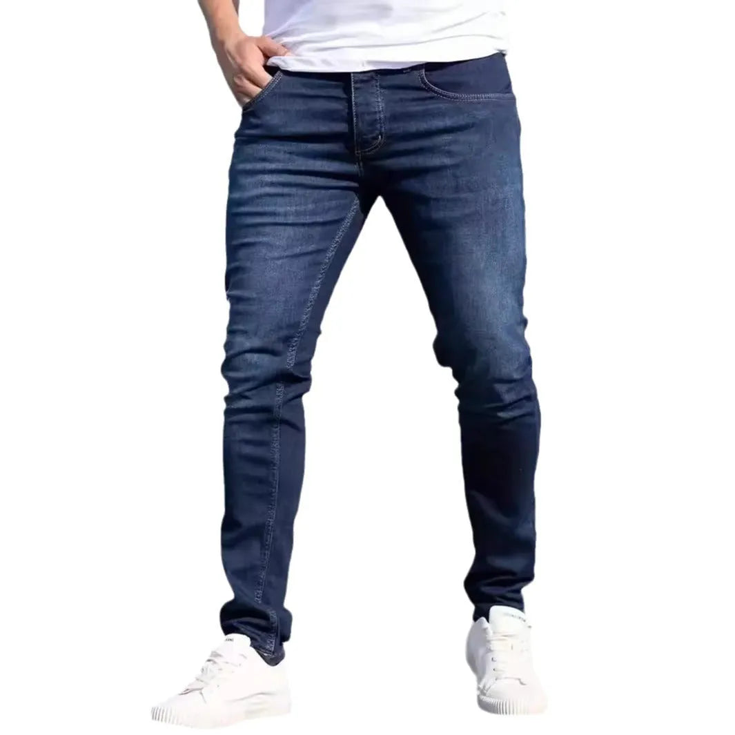 Men's slim-fit dark blue cotton jeans with mid waist and zipper fly