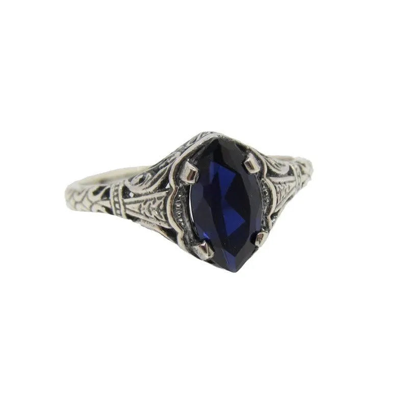 Silver women's geometric hollow ring in electroplated alloy on a plain background.